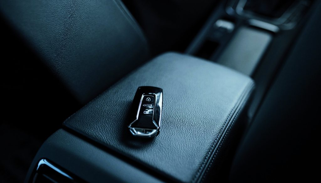 Close up photo of keys lying donw inside brand new modern car