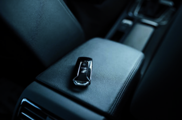 Close up photo of keys lying donw inside brand new modern car